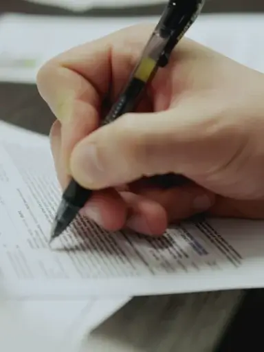 man signing non-solicit and non-compete agreement