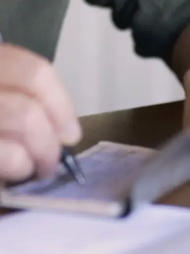 man signing non-solicit and non-compete agreement